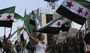 Protesters shout slogans against Syria's President Bashar al-Assad as they wave Syrian opposition flags during a protest marking two years since the start of the uprising, at Avenida Paulista in Sao Paulo March 15, 2013. REUTERS/Nacho Doce