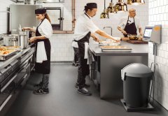 Male and female chefs preparing food in commercial kitchen