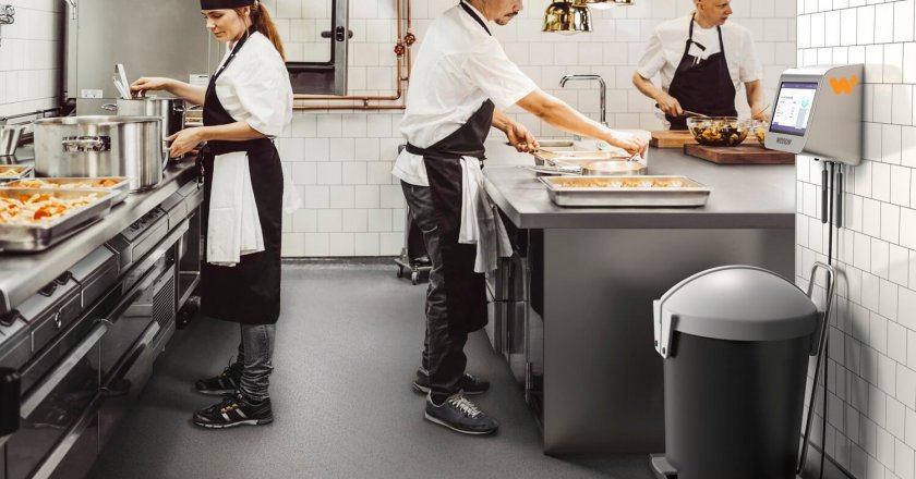 Male and female chefs preparing food in commercial kitchen