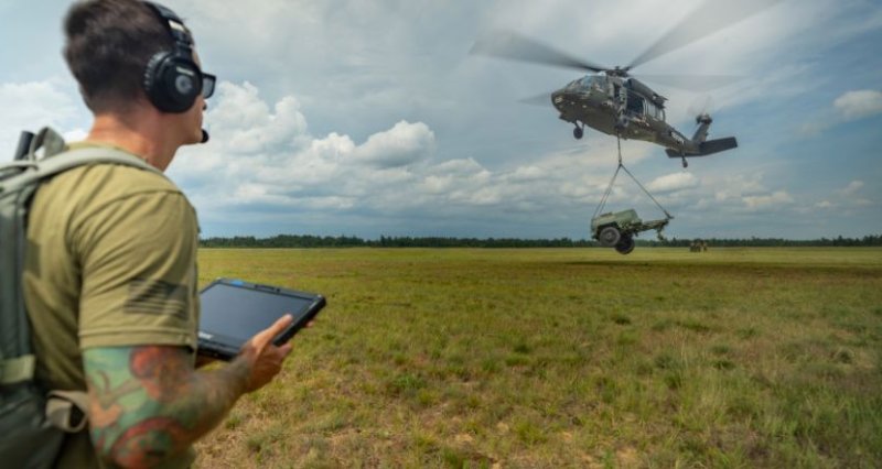 U.S. Army National Guard Sergeant uses a tablet to command the Sikorsky OPV Black Hawk as it autonomously transports a 2,900-pound water buffalo sling load for the first time during Northern Strike in Michigan. Photo courtesy Sikorsky, a Lockheed Martin company.